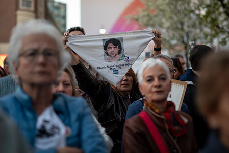 A woman raises a handkerchief during a rally commemorating the 50th anniversary of the Argentine civic-military dictatorship. Dozens of people gathered in Madrid's Plaza de Callao to commemorate Argentina's National Day of Remembrance for Truth and Justice, to remember and demand justice for the victims of the last civic-military dictatorship, which began 50 years ago.