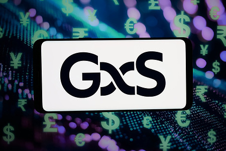 In this photo illustration, the logo of Singaporean financial company GXS Bank is displayed on a smartphone in front of abstract background on computer screen.