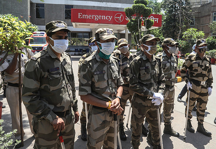 Indian security personnel stand on guard for any clash between Relatives of the deceased and hospital staff at Jaipur Golden hospital where at least 25 Covid-19 patient passed away while in ICU the previous night due to shortage of medical oxygen.According to data released by the Union Health Ministry, 346,786 new Covid-19 cases and 2,624 deaths were reported in the last 24 hours. The country has so far reported 189,544 deaths.