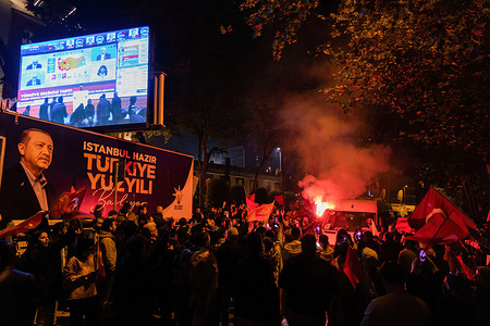 Erdogan supporters celebrate outside the headquarters of the Justice and Development Party in Istanbul ahead of the announcement of the final results of the Turkish presidential elections.