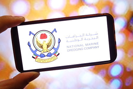 In this photo illustration, the National Marine Dredging Company logo is seen displayed on a smartphone screen.