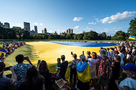 People hold a huge Ukrainian flag in honor of Ukraine's Independence Day in Sheep Meadow in New York City's Central Park. 
Its dimensions are 60 x 40 meters.