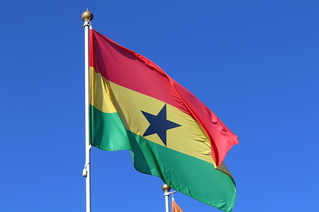 The national flag of the Republic of Ghana, fluttering in the wind on a flagpole in Saint Petersburg.