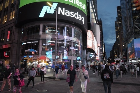 People walk past the Nasdaq MarketSite Times Square event space in Times Square, Manhattan, New York City.