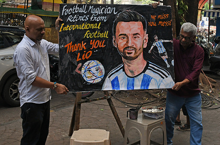 Teachers from Gurukul school of art seen carrying a painted poster paying tribute to Argentina football player, Lionel Messi who announced his retirement from international football.