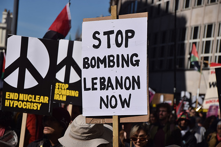A protester near Russell Square holds a 'Stop bombing Lebanon now' placard during a march against the US and Israel's war on Iran.