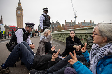 Palestine Action supporters are detained and arrested by Metropolitan Police Officers during the demonstration. After hanging a banner from Westminster Bridge which supported the terrorist organisation 'Palestine Action', activists were detained and arrested by the Metropolitan Police. Since July 2025, being a member or showing support for Palestine Action would result in arrest and prosecution under the terrorism act 2000.