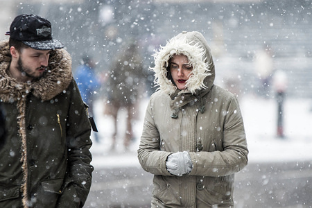 A couple seen walking in central London under heavy snow.