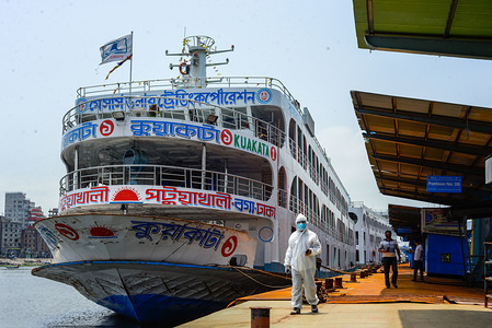 An employee of boat terminal is seen wearing a protective suit while monitoring as the boat terminal reopens after the Coronavirus (COVID-19) lockdown crisis.
Bangladesh government is likely to end the ongoing nationwide lockdown to contain Covid-19, and allow all offices, businesses and public transport to resume operation starting May 31.