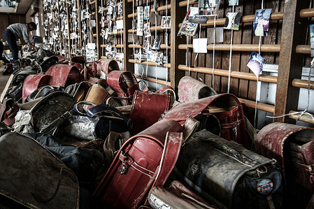 A man searches through debris washed away by the tsunami in Ishinomaki, Miyagi Prefecture where many residents went missing after the Great East Japan Earthquake and tsunami.