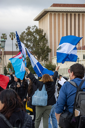 High school students from Marshal High School, Pasadena High School and Blair High School hold flags as they protest against recent mass deportations.