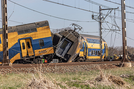 A view of a damaged carriage of the crashed train. A train collided with heavy construction equipment and derailment of the carriages near Leiden and the Hague. The Dutch railway crash killed one person and injured 30. Emergency services workers and police were on the scene to assess the damage. The accident took place in Voorschoten in the Netherlands.