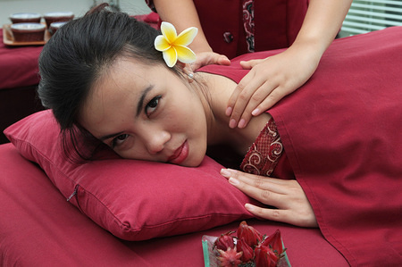 A young woman is seen being massaged at a beauty spa treatment. The spa beauty treatment business is growing along with the changing lifestyle of urban women.