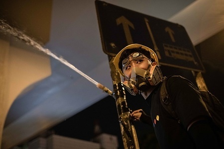 Protester spray water on teargas canisters. 
Protesters clashed with the Hong Kong police at the end of the Civil Human Rights Front march.
Hong Kong demonstrators gathered for another weekend of protests against the controversial extradition bill and with a growing list of grievances, maintaining pressure on Chief Executive Carrie Lam.