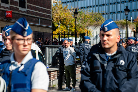 A man from an extreme far-right group is seen being arrested by the riot police during the demonstration.
Since the Vlaams Belang (VB) a right-wing populist, Flemish nationalist political party achieved the second-highest vote in Flanders in the May regional elections, and also was excluded from the negotiations still taking place to form a new regional government. The extremist group 'Bloed, Bodem, Eer en Trouw' (BBET, Blood, Soil, Honour, and Loyalty) organized a protest against the exclusion of Vlaams Belang from talks on the new Flemish government. Around thirty supporters trying to gather at the Place d'Espagne in the center of Brussels, but they were stopped by the riot police and were put under arrest.