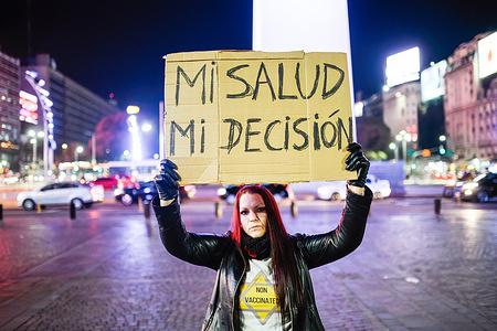 A protester holds a placard reading "My Health My decision" during a protest against the health passport and the World Health Organization.Protesters take to the streets of Buenos Aires in protest against the proposed COVID-19 health passports that would require every person vaccinated.