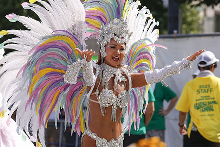 A samba dancer performs through the streets of the traditional Asakusa district during the 40th Asakusa Samba Carnival Parade Contest. The Asakusa Samba Carnival Parade Contest, first held in 1981 has become a major summer-ending tradition drawing around 500,000 visitors each year. Inspired by the Rio de Janeiro Carnival in Brazil, participating teams bring vibrant energy to the streets of Asakusa with powerful bateria drum troupes, dynamic dancers, carnival-inspired music and elaborately decorated “alegoria” floats creating the largest samba carnival in the Northern Hemisphere.