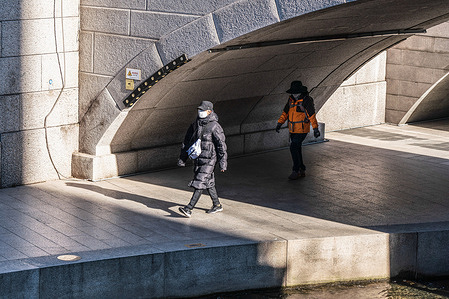 People wearing face masks as protective measure against coronavirus (COVID-19) walk at Cheonggyecheon.
South Korea reached 1,097 new confirmed COVID19 cases, which is the highest record since the virus broke out in South Korea.