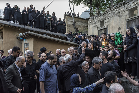 People collect money during the ceremony.
"Tasht gardani" is a religious ceremony during Muharram in Masuleh. At the event, the Masuleh people move a ‘’tasht’’ around the city to raise money which is spent on the mosque during Muharram. Masuleh is a historical city in northern Iran and in Gilan province.
