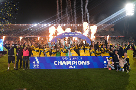 The Central Coast Mariners FC team celebrates with a trophy and Champions banner following their victory in Isuzu UTE A-League 2023-24 season Grand Finals match against Melbourne Victory FC held at the Industree Group Stadium. Final score; Central Coast Mariners FC 3:1 Melbourne Victory FC.