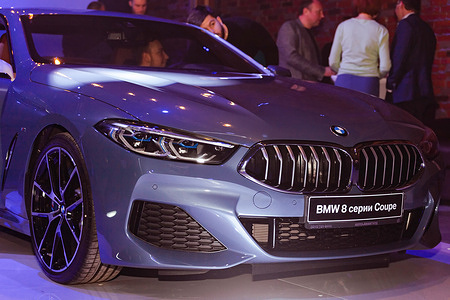 The hood of the new BMW 8 Coupe is seen during the exhibition.At the end of November 2018, a closed presentation of the new BMW X5 and BMW 8 took place in Moscow. The event for BMW's top customers was held in the stylish LOFT # 2 loft, where two new car models were presented. Guests were offered delicious food and drinks, an interesting photo zone was organized.The presentation of the new BMW X5 began with a wonderful show and continued with a lottery. Musical groups and presenters with competitions performed in front of the guests.