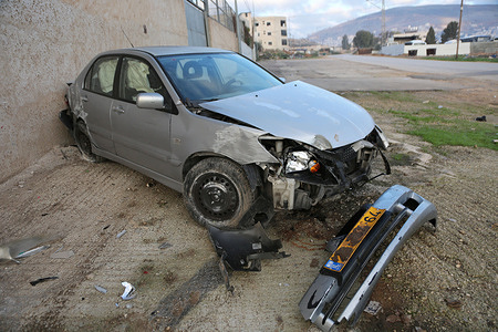 A Jewish settler's car seen crashed after he entered Joseph's Tomb to perform Jewish prayers. The settler ran over a Palestinian child, causing the car to overturn and injuring two settlers.