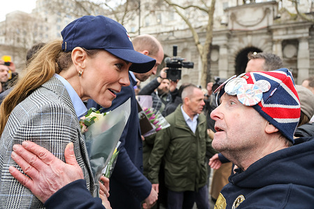 Catherine, Princess of Wales speaks with a Royal fan, John Loughrey, after she visited the RNLI (Royal National Lifeboat Institution) Tower Lifeboat Station in London with William, Prince of Wales, where they heard about the work of staff and volunteers saving lives on the River Thames, as the RNLI marks the 25th anniversary of its lifeguard service.