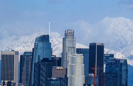After a rare snowstorm in Southern California, snow-covered San Gabriel mountain range are seen behind downtown Los Angeles skyline.