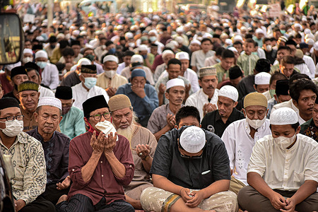 Muslim men offer prayers during Eid 1443 Hijriyah / 2022 AD near a church in Jatinegara. This year, the Indonesian government allowed Eid prayers to be held together after two years of being canceled due to the Covid-19 pandemic.