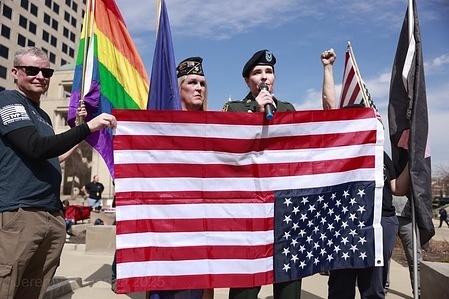 Protesters hold an upside down American flag, a sign of distress, United States military veterans and their supporters protest against the Trump administration’s cuts to the Department of Veterans Affairs (VA) and other changes affecting veterans and the military outside the Indiana Statehouse in Indianapolis. The unofficial grassroots protest was sparked by a flyer posted by the 50501 movement and discovered online by veterans across the United States. Veteran marches also took place in Washington, D.C., and at other state capitols across the country.