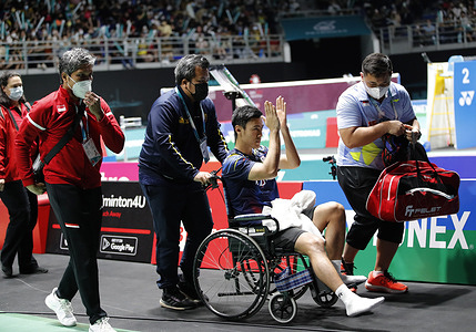 Shesar Hiren Rhustavito of Indonesia seen in a wheelchair after his injury during the game against Kento Momota of Japan of the Men's Single quarter-finals match of the Petronas Malaysia Open 2022 at Axiata Arena, Bukit Jalil.