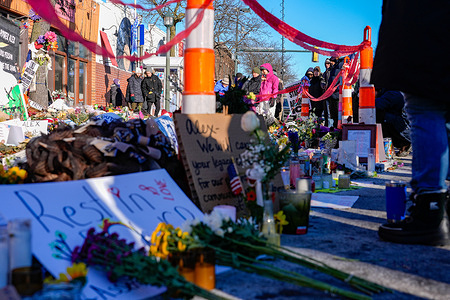 People seen visiting the Alex Pretti memorial site. Memorials continue after ICE surged enforcement in the city and escalated attacks on civilians.
