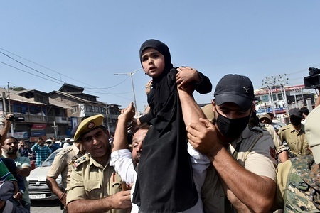 Indian policemen detain a young Kashmiri Shiite mourner, as they defied restrictions during a Muharram procession in Srinagar, Kashmir. Police foiled attempt of over a dozen of Shiite mourners to carry out procession on eighth day of Muharram.