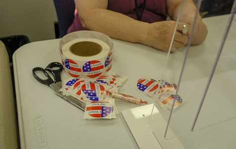 A worker helps to cut out “I Voted” stickers for voters at Election Central during the first day of early voting in Monroe County, Indiana.
Over 100 voters lined up outside Election Central during the first day of early voting in Monroe County, Indiana. The doors for early voting opened at 8 a.m. but the line already stretched down the street, around the corner and nearly to Rogers.