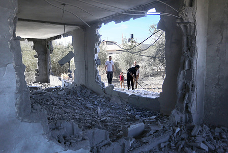 Palestinians inspect the home of the Palestinian perpetrator of the May 2024 shooting attack at the Tayasir checkpoint, north of the Jordan Valley in the West Bank, after Israeli forces demolished his home in the northern West Bank city of Tubas. The shooting, carried out by a Palestinian gunman, killed two Israeli soldiers and wounded eight others.