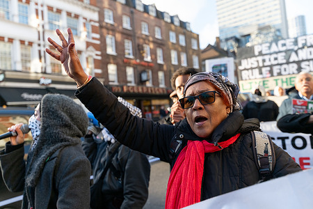 A woman chants slogans during the demonstration.. Protesters marched through central London to oppose the war in Sudan, calling for an end to violence against civilians and greater international action to address the humanitarian crisis.