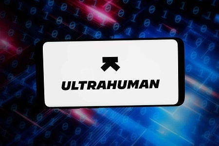 In this photo illustration, the logo of health technology company Ultrahuman is displayed on a smartphone in front of abstract background on computer screen.