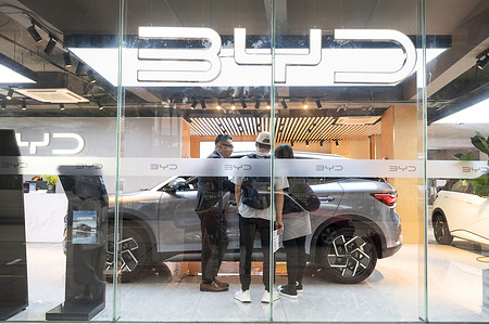 Shoppers are seen at the Chinese automaker BYD official authorized car dealer store displays its Seal car model in Hong Kong.