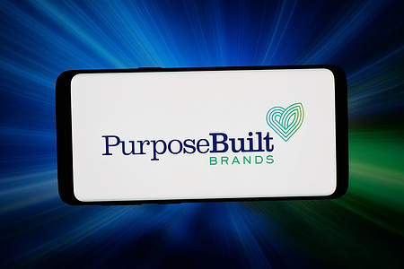 In this photo illustration, the US company PurposeBuilt Brands Inc. logo is seen displayed on a smartphone in front of abstract background on computer screen.