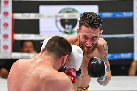 Ruslan Madiyev (L) and Florent Dervis (R) exchange punches during their welterweight bout. Ruslan Madiyev defeats Florent Dervis by seventh-round stoppage to successfully defend his WBA Asia 147-pound title in Bangkok, Thailand.