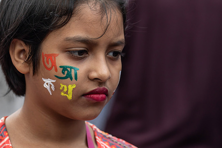 A kid seen with paint on her face at the Martyr's Monument, or Shaheed Minar during the International Mother Language Day in Dhaka. Bangladeshis pay tribute at the Martyr's Monument, or Shaheed Minar, on International Mother Language Day in Dhaka, International Mother Language Day is observed in commemoration of the movement where a number of students died in 1952, defending the recognition of Bangla as a state language of the former East Pakistan, now Bangladesh.