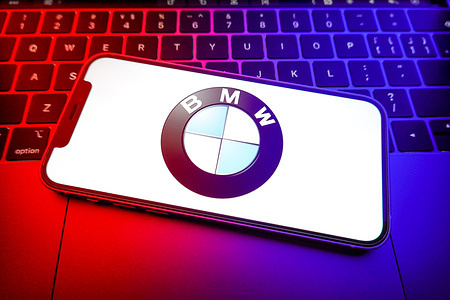 In this photo illustration, a BMW Group logo is displayed on the screen of a smartphone.