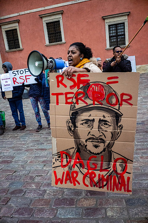 A protester holds a placard as she addresses the gathered demonstrators. On the afternoon of the 8th of November, protesters gathered to stand against the Rapid Support Forces (RSF) committing mass atrocities against civilians in the Darfur region of Sudan. They demand protection of civilians and an end to the horrors. Since the takeover of the city of El Fashir last month killings, rape, torture and ethnic cleansing are being reported another new stage in the genocidal war being waged across the North African country.