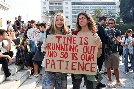 Protesters hold a placard during the demonstration.
Thousands of activists protested at Syntagma square for the intentional human activity in climate change, trying to raise awareness about its future effectiveness.