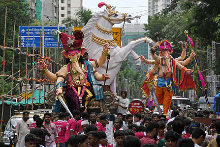 Idols of elephant-headed Hindu god, Ganesha carried amidst of people from the workshop to the pandal (temporary shelter) ahead of the festival. Installing large idols of Ganesha in pandal ahead of the festival helps the local organisers to embellish the surrounding backdrop and decorations according to the size and design of the idol. The ten day festival of Ganesh Chaturthi will be celebrated across the country from 14th September till 25th September 2026 with joy and devotion amongst the Hindu community.