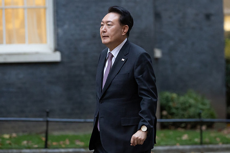 President of South Korea Yoon Suk Yeol walks outside 10 Downing Street in London ahead of a bilateral meeting.