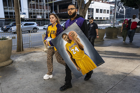 LOS ANGELES, UNITED STATES - FEBRUARY 02 2020: A fan holds a painting of Kobe Bryant near the Staples Center in Los Angeles.
Kobe and his daughter Gianna were among the nine people who died in a helicopter crash.