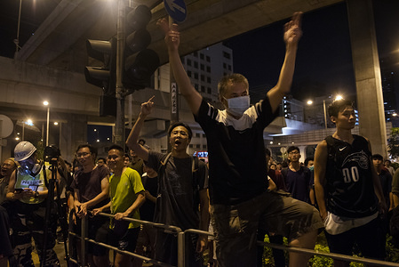 Protesters shout profanities against riot police officers. 
Hong Kong protesters ignored police warnings and continued with the latest series of demonstrations targeting Hong Kong government and numerous police stations.