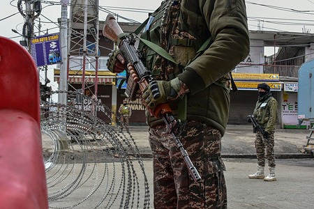 Paramilitary troopers stand alert at a temporary check-post during India's 77th Republic day celebrations in Srinagar the summer capital of Jammu and Kashmir. The authorities in Kashmir valley organized official functions to mark the 77th Republic Day amidst stepped up security vigil. Checkpoints have been erected at many places and frisking has been intensified.