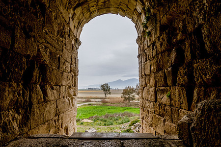 View of countryside from inside Miletus ruins in Turkey, a stunning and extensive collection of ancient buildings that showcase the remarkable engineering and architecture of the Hellenistic and Roman eras.